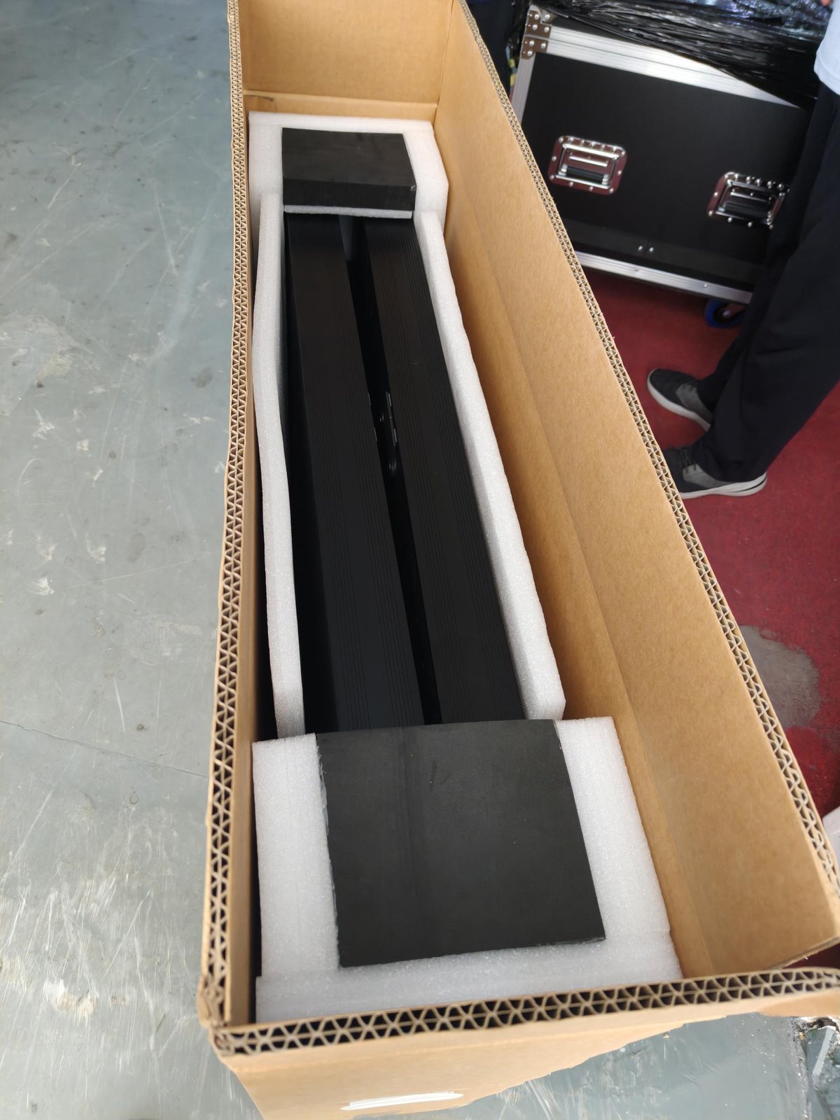 Open cardboard box with foam inserts inside, poster slot visible